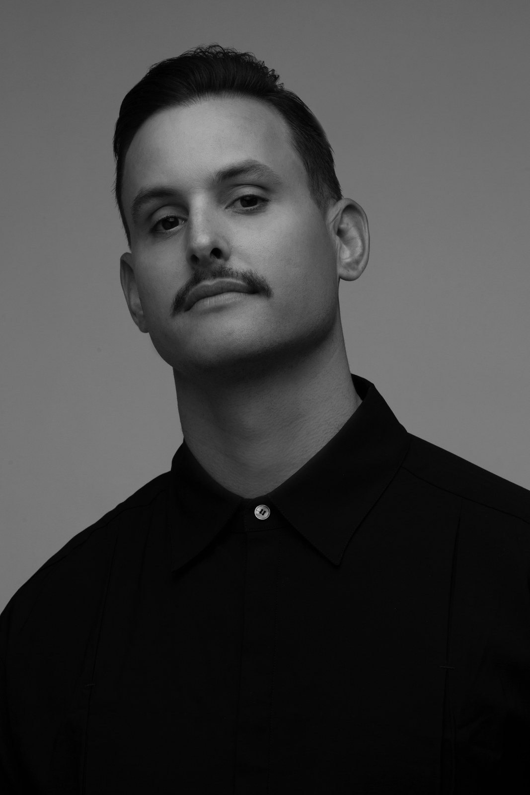 KENZ in a black-and-white studio portrait